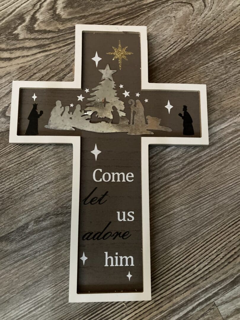 White-framed wooden cross with nativity scene